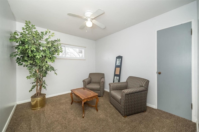 living area featuring carpet and ceiling fan