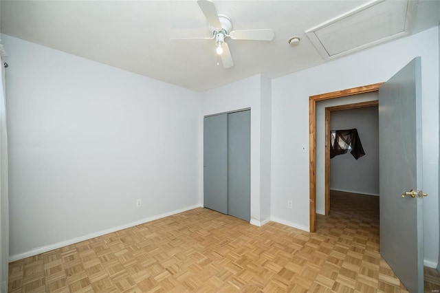 unfurnished bedroom with ceiling fan, a closet, and light parquet flooring