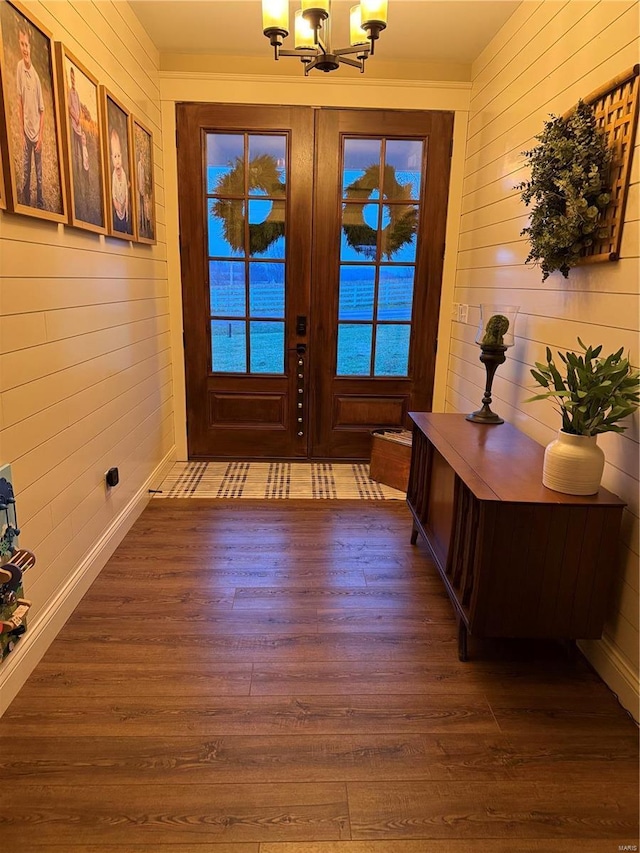 entryway featuring a chandelier, dark wood-type flooring, and french doors