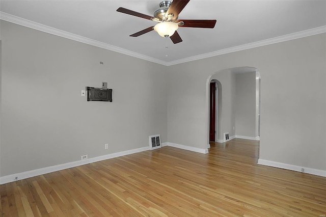 empty room featuring ceiling fan, light hardwood / wood-style floors, and crown molding