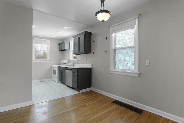 kitchen with stainless steel dishwasher, plenty of natural light, sink, and white stove