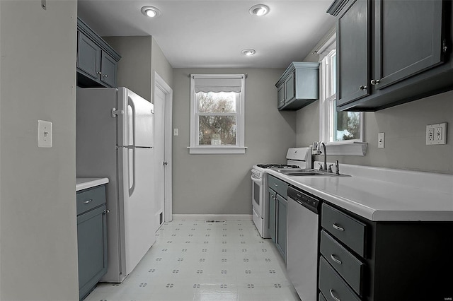 kitchen with gray cabinets, sink, and white appliances