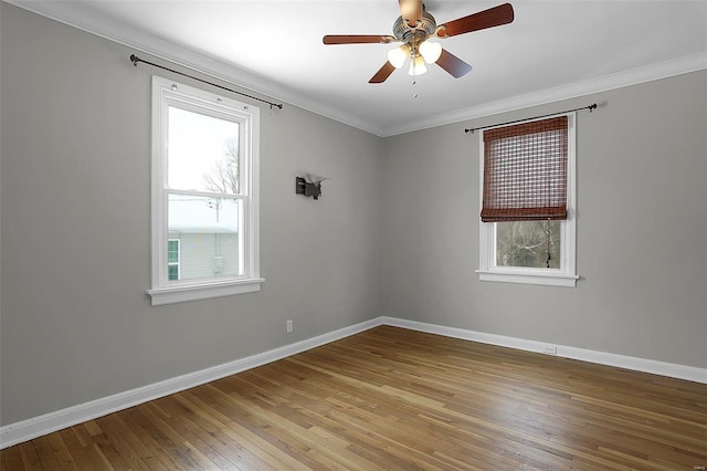 spare room with ceiling fan, ornamental molding, and light wood-type flooring