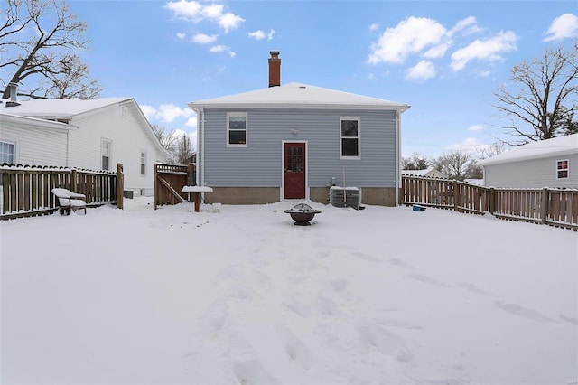 snow covered property with a fire pit