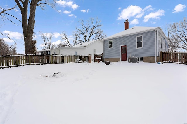 view of snow covered rear of property