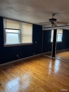 unfurnished room featuring hardwood / wood-style flooring and ceiling fan