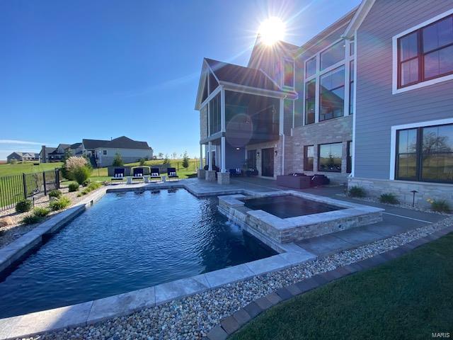 view of swimming pool featuring an in ground hot tub, a patio, and an outdoor fireplace