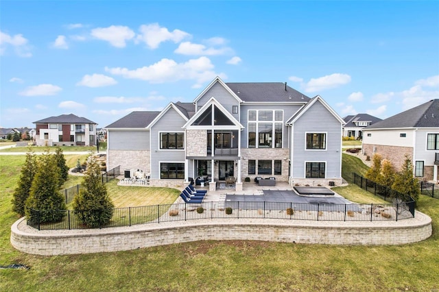 rear view of property featuring a yard, an outdoor hangout area, and a patio area