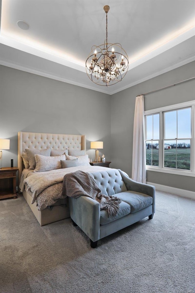 carpeted bedroom with a raised ceiling, crown molding, and an inviting chandelier