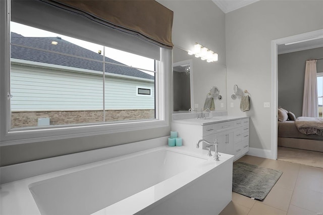 bathroom with ornamental molding, vanity, tile patterned floors, and a tub