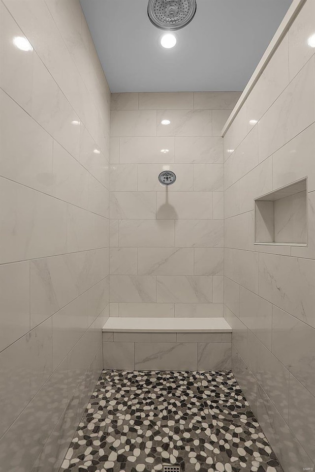 bathroom with a tile shower