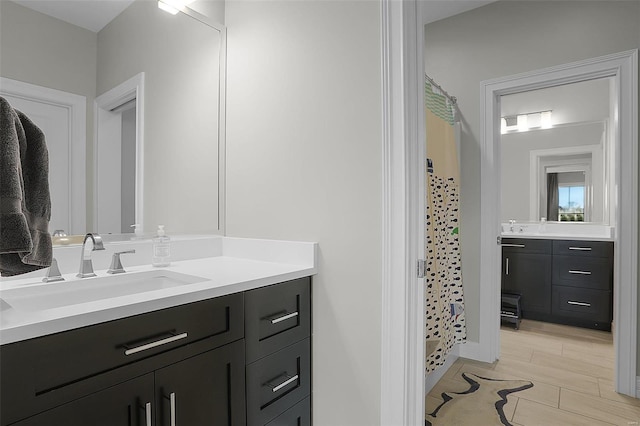 bathroom featuring hardwood / wood-style flooring, vanity, and a shower with shower curtain