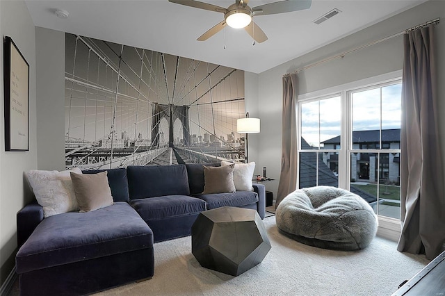 living room featuring carpet and ceiling fan