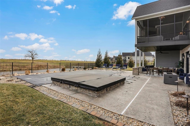 view of patio / terrace with a sunroom and ceiling fan