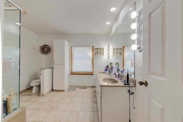 bathroom featuring tile patterned flooring, vanity, and toilet