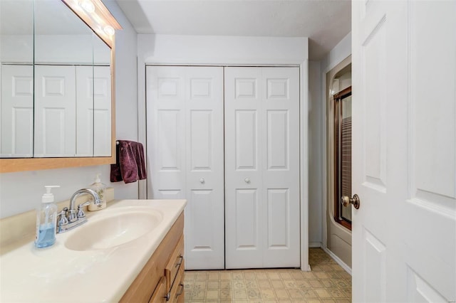 bathroom with vanity and combined bath / shower with glass door