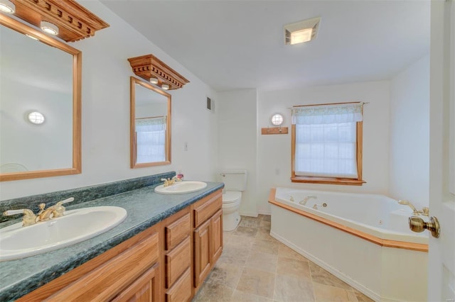 bathroom featuring toilet, a washtub, and vanity