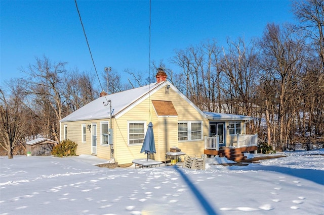 snow covered property with covered porch