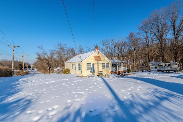 view of snow covered back of property