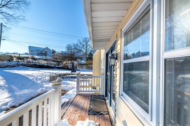 view of snow covered back of property