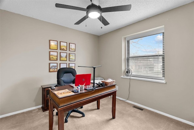 home office with ceiling fan, light colored carpet, and a textured ceiling