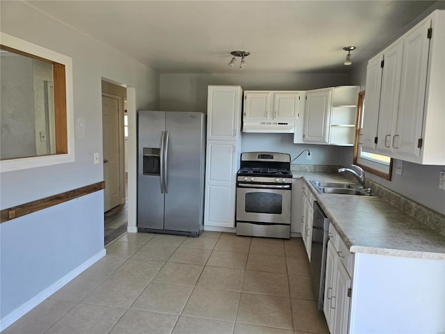 kitchen featuring white cabinets, stainless steel appliances, light tile patterned flooring, and sink