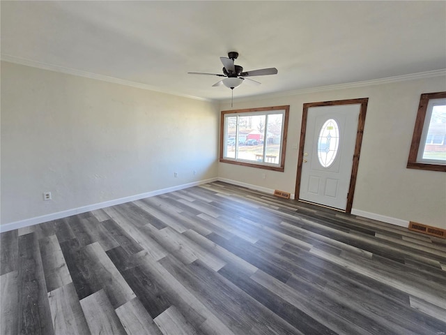 foyer entrance featuring ceiling fan, dark wood-type flooring, and ornamental molding