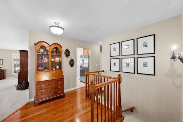 hallway with hardwood / wood-style floors