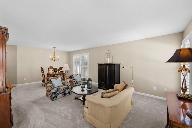 carpeted living room featuring a notable chandelier