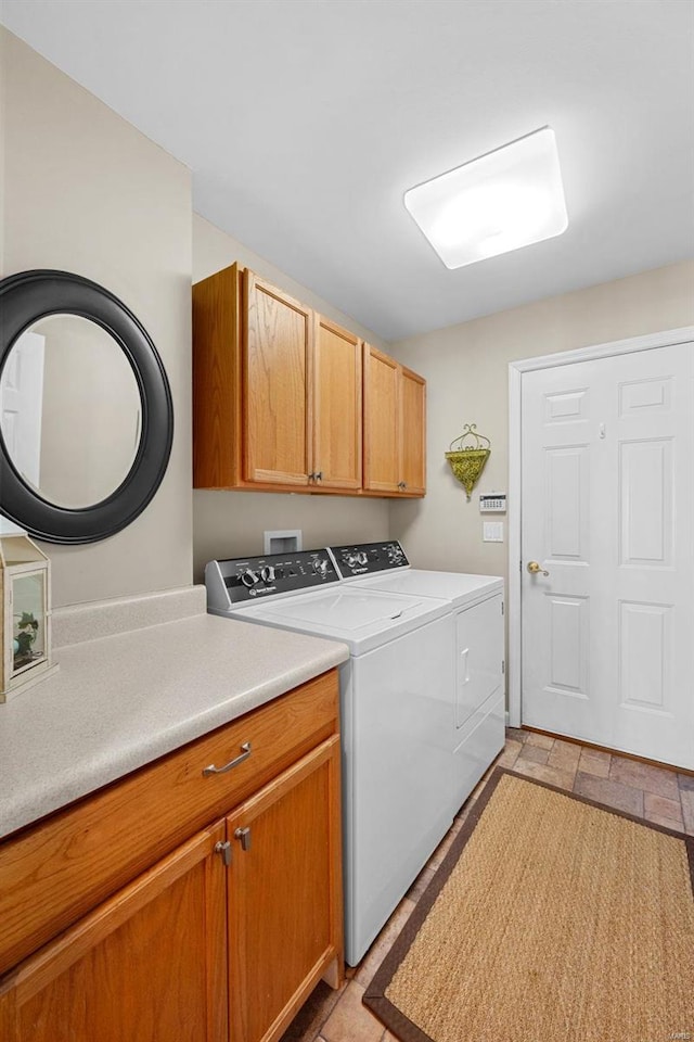 laundry room with cabinets and washer and dryer