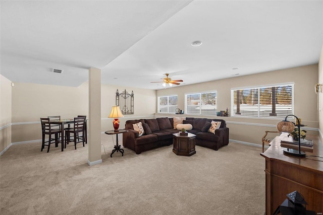 living room featuring light carpet and ceiling fan