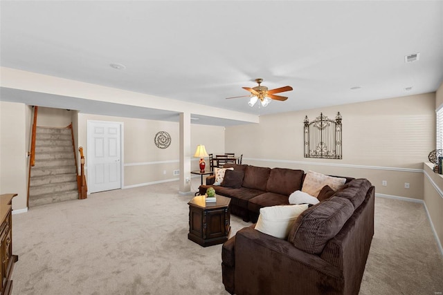 carpeted living room featuring ceiling fan