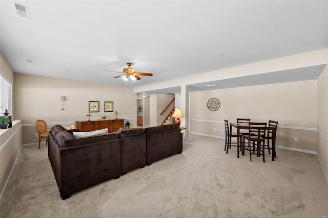 living room featuring ceiling fan and light colored carpet