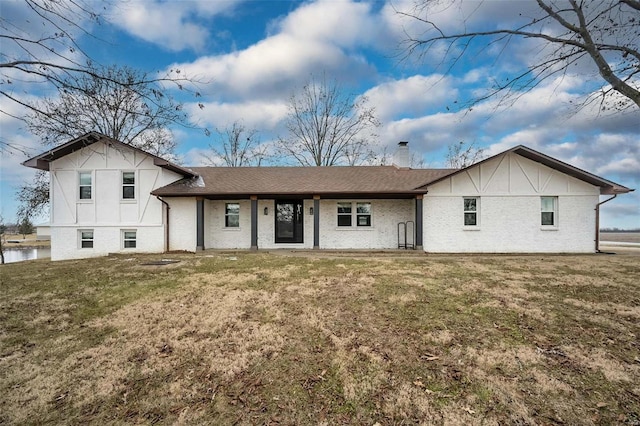 back of property featuring a yard