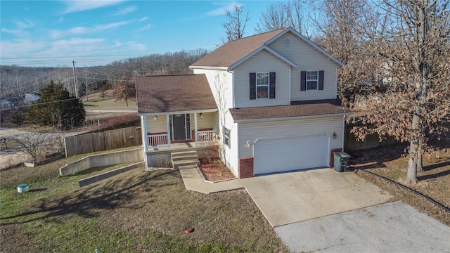 view of front of property featuring a garage, a front yard, and covered porch