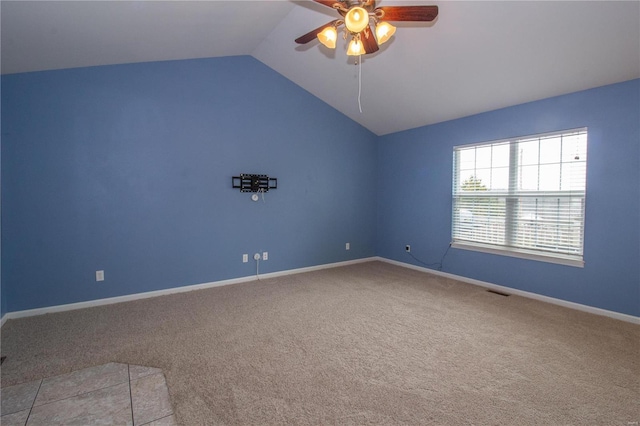 carpeted spare room featuring ceiling fan and lofted ceiling