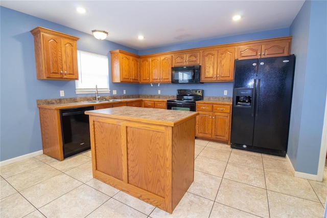 kitchen with sink, a center island, light tile patterned floors, and black appliances