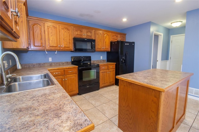 kitchen with light tile patterned flooring, a center island, sink, and black appliances