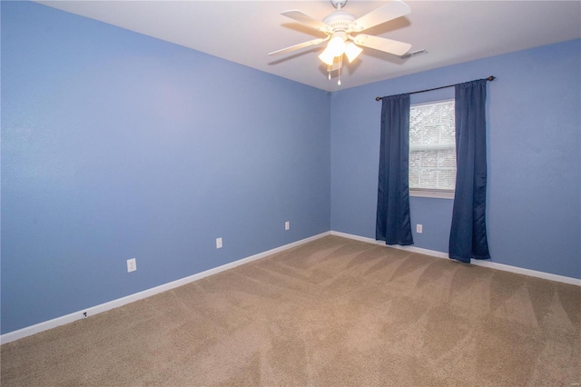 unfurnished room featuring ceiling fan and carpet flooring