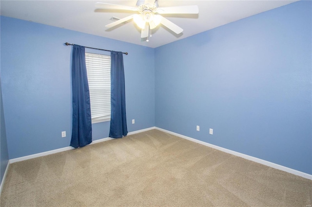 carpeted spare room with ceiling fan