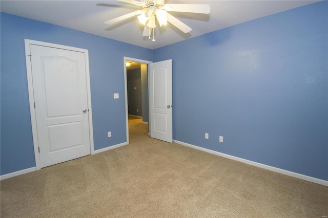 unfurnished bedroom featuring light colored carpet and ceiling fan