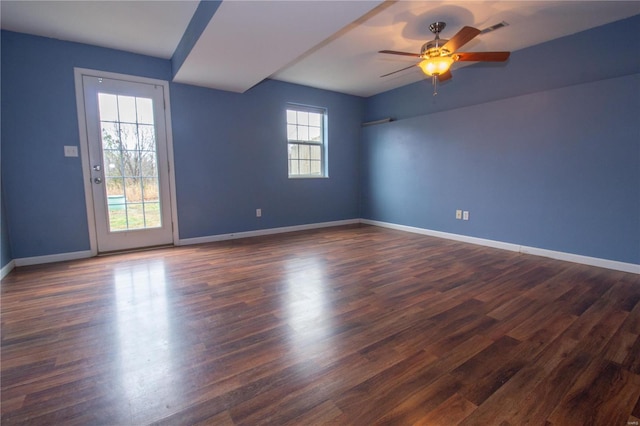 empty room featuring dark hardwood / wood-style flooring and ceiling fan