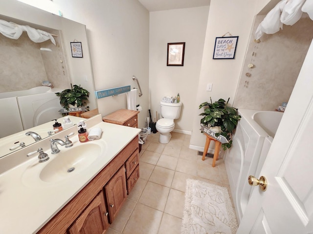 bathroom with toilet, vanity, tile patterned floors, and a bathing tub