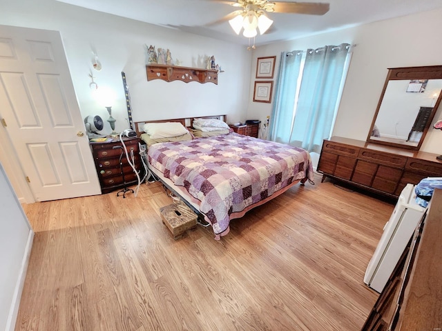 bedroom with ceiling fan and light hardwood / wood-style floors