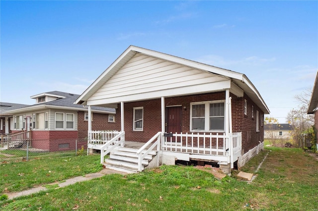 view of front facade with a front yard and a porch