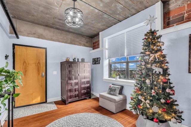 sitting room featuring an inviting chandelier and light wood-type flooring