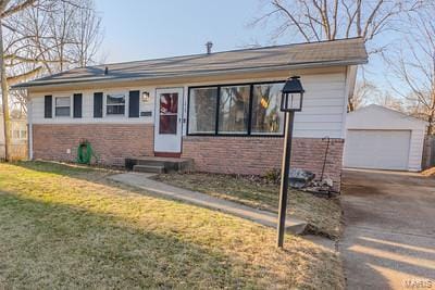 view of front of home with an outdoor structure, a garage, and a front lawn