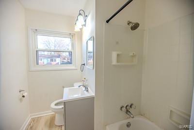 full bathroom with vanity, toilet, shower / bathtub combination, and hardwood / wood-style floors