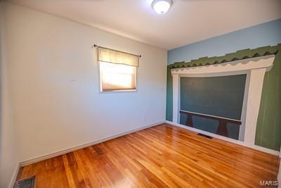 unfurnished room featuring wood-type flooring