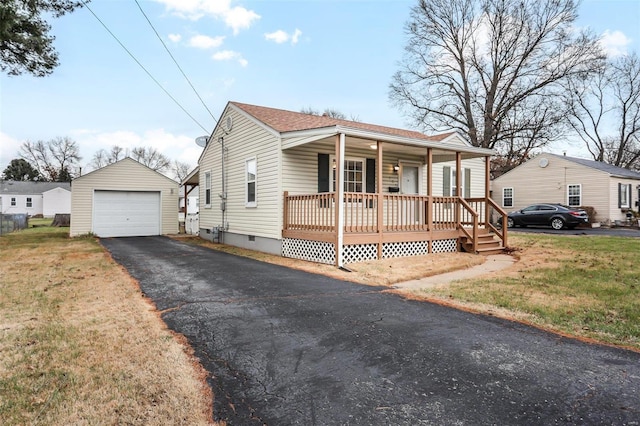 view of front of home featuring a front lawn, covered porch, an outdoor structure, and a garage